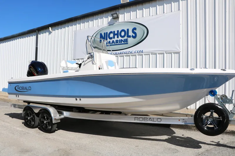 Slide: The Image of 2026 Robalo 226 Cayman boat on trailer at Nichols Marine dealership. - 2