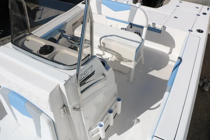 Slide: The Image of 2026 Robalo 226 Cayman boat interior with white and blue seating and console. - 25