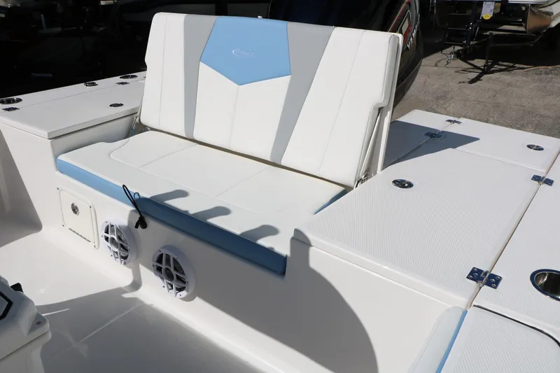 Slide: The Image of 2026 Robalo 226 Cayman boat seating area with storage compartments and speakers. - 28