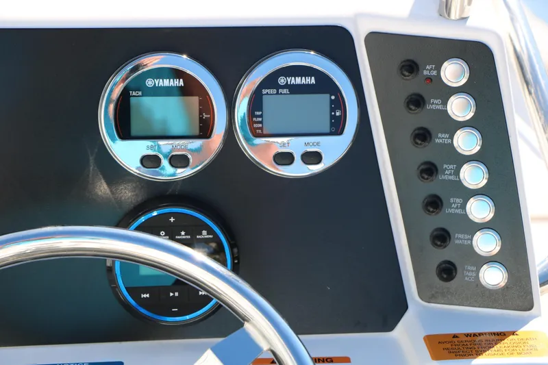 Slide: The Image of Dashboard of 2026 Robalo 226 Cayman boat with Yamaha gauges and control buttons. - 30