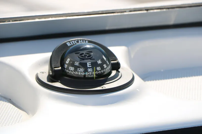Slide: The Image of Compass on 2026 Robalo 226 Cayman boat dashboard in sunlight. - 31
