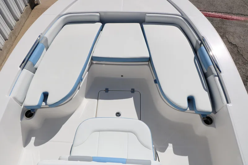 Slide: The Image of 2026 Robalo 226 Cayman boat interior with white and blue cushioned seating. - 33