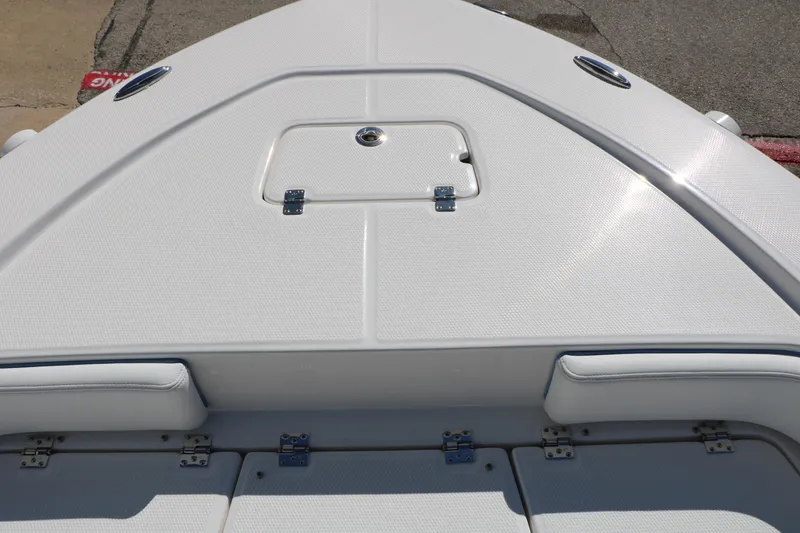Slide: The Image of Bow deck of 2026 Robalo 226 Cayman boat with storage hatch and seating. - 34