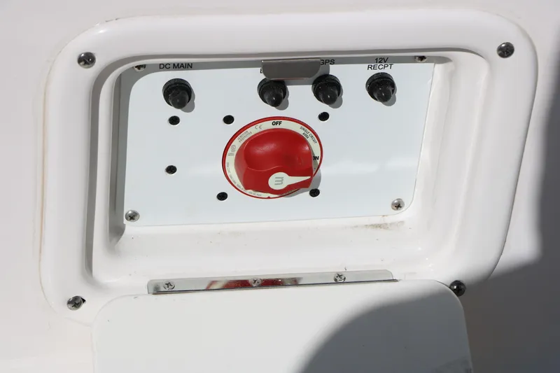 Slide: The Image of Control panel of 2026 Robalo 226 Cayman boat with switches and red dial. - 35