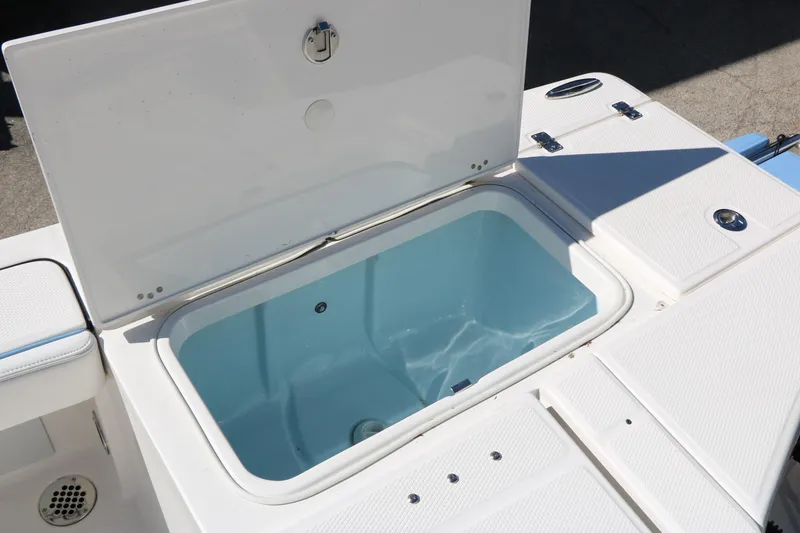 Slide: The Image of Open storage compartment on 2026 Robalo 226 Cayman boat, featuring a spacious interior. - 36