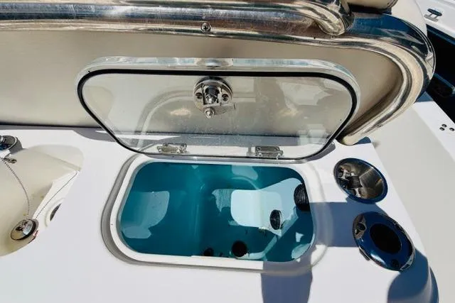 Slide: The Image of Open storage compartment on a 2021 Boston Whaler 270 Dauntless boat deck. - 10