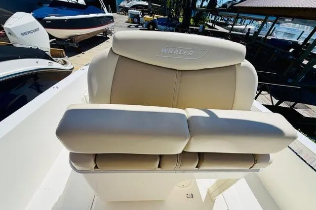 Slide: The Image of Boston Whaler 270 Dauntless 2021 boat seat, beige upholstery, docked at marina. - 11