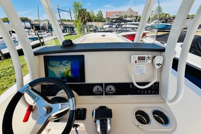 Slide: The Image of 2021 Boston Whaler 270 Dauntless helm with navigation screen and controls. - 14