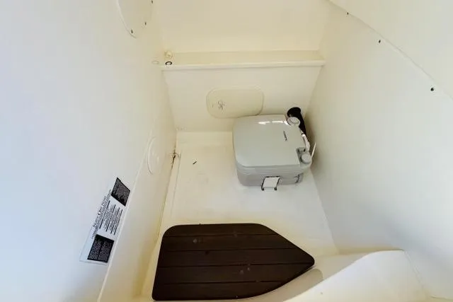 Slide: The Image of Interior of 2021 Boston Whaler 270 Dauntless boat with compact marine toilet. - 18
