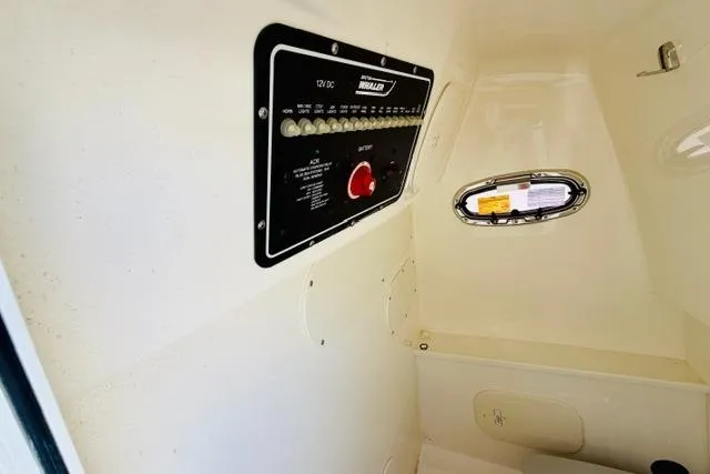 Slide: The Image of Control panel inside 2021 Boston Whaler 270 Dauntless boat cabin with porthole view. - 19