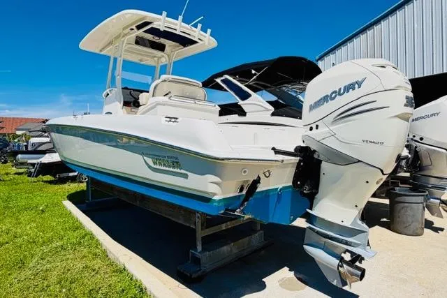 Slide: The Image of 2021 Boston Whaler 270 Dauntless boat with Mercury engine, displayed outdoors. - 2