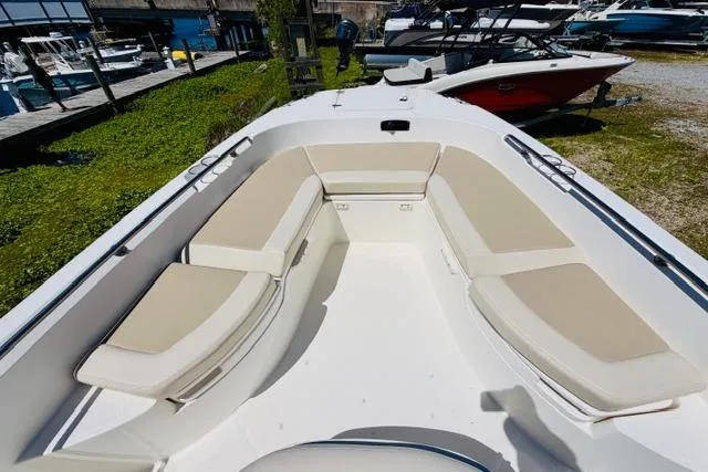 Slide: The Image of 2021 Boston Whaler 270 Dauntless boat with spacious seating area, docked outdoors. - 25