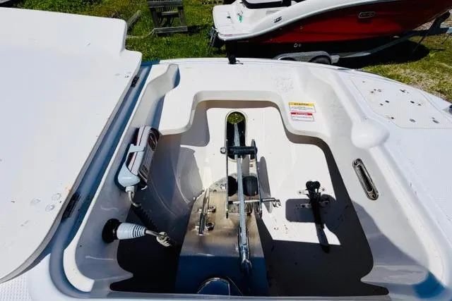 Slide: The Image of 2021 Boston Whaler 270 Dauntless anchor compartment, open lid, showcasing anchor storage. - 26
