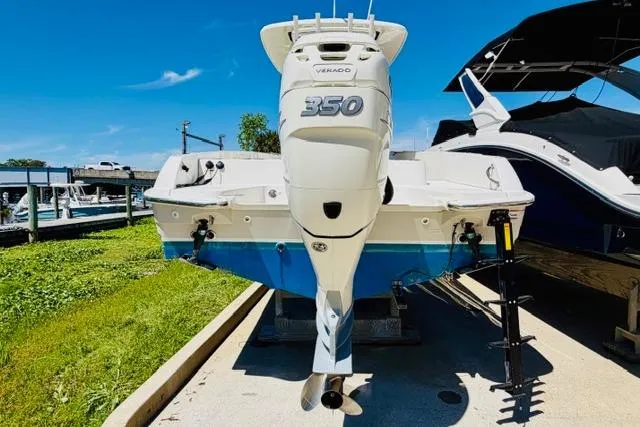Slide: The Image of 2021 Boston Whaler 270 Dauntless with powerful 350 Verado engine, docked outdoors. - 3