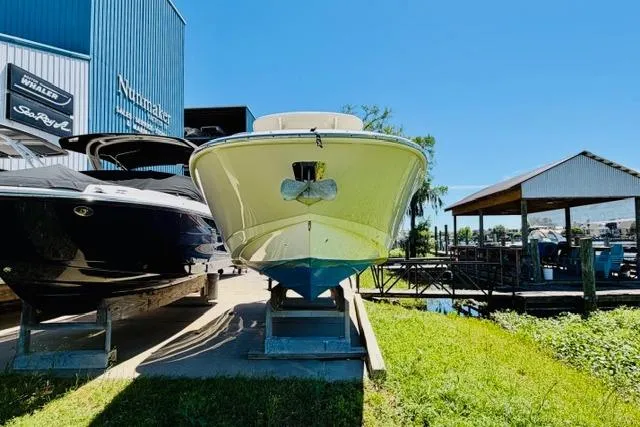 Slide: The Image of 2021 Boston Whaler 270 Dauntless boat displayed outdoors on a sunny day. - 6
