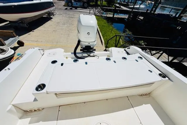 Slide: The Image of 2021 Boston Whaler 270 Dauntless boat stern with outboard motor in marina setting. - 7