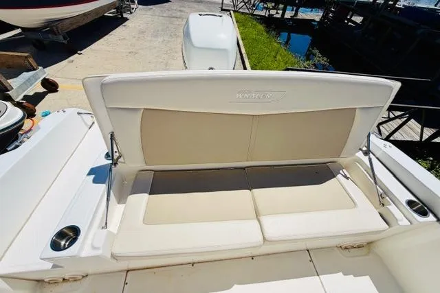 Slide: The Image of 2021 Boston Whaler 270 Dauntless boat seating area with beige cushions. - 9