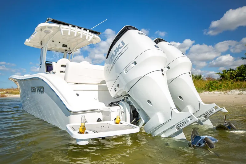 Slide: The Image of Manufacturer Provided Image: 2026 Sea Pro 265FLX Sandbar boat with dual Suzuki engines, anchored near a sandy shore. - 2