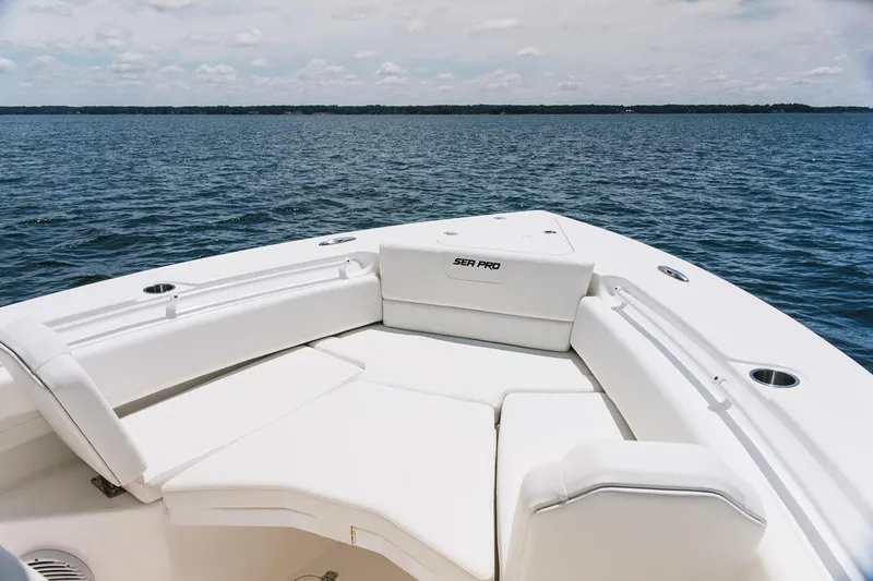 Slide: The Image of Manufacturer Provided Image: 2026 Sea Pro 265FLX Sandbar boat with white seating, on calm water. - 4