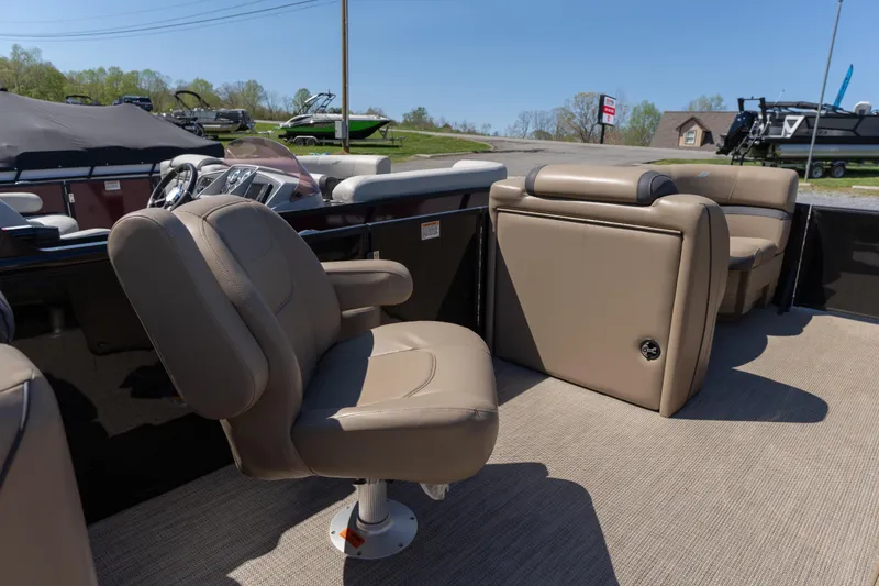 Slide: The Image of 2025 Starcraft EXS 3 boat interior with beige seating and modern dashboard. - 13