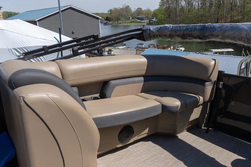 Slide: The Image of Luxurious seating on 2025 Starcraft EXS 3 boat, docked by a serene lakeside. - 14