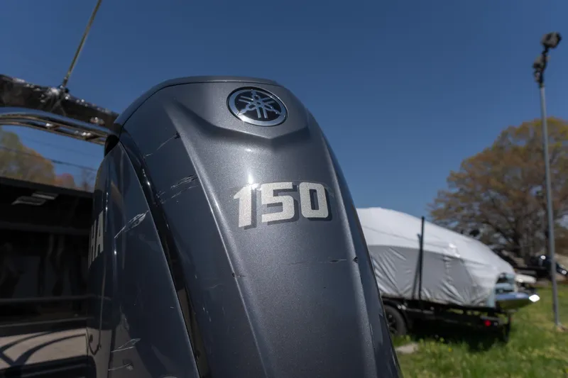 Slide: The Image of Yamaha 150 outboard motor on a 2025 Starcraft EXS 3 boat under clear blue sky. - 15