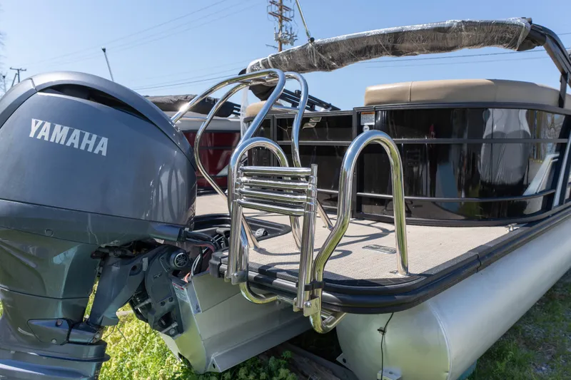 Slide: The Image of 2025 Starcraft EXS 3 pontoon boat with Yamaha outboard motor and stainless steel ladder. - 2