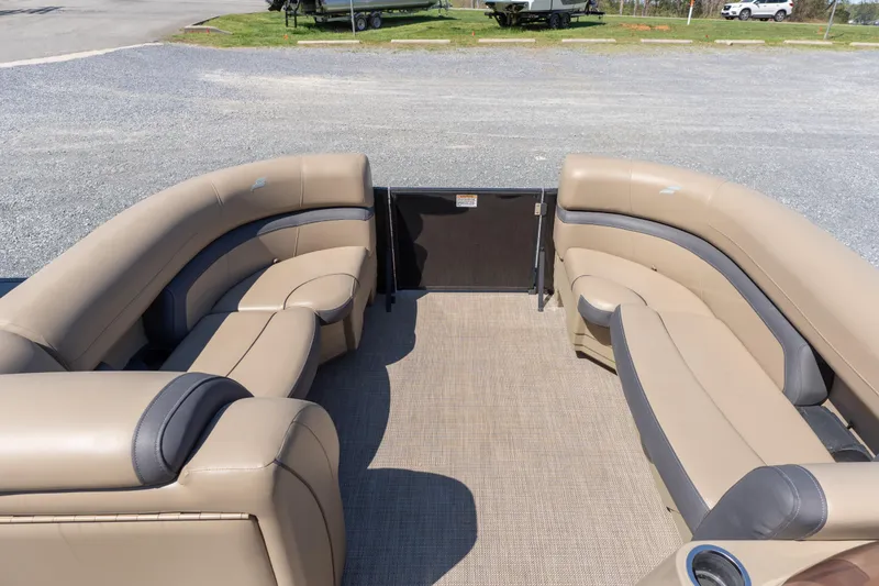 Slide: The Image of 2025 Starcraft EXS 3 pontoon boat interior with beige seating and spacious layout. - 4