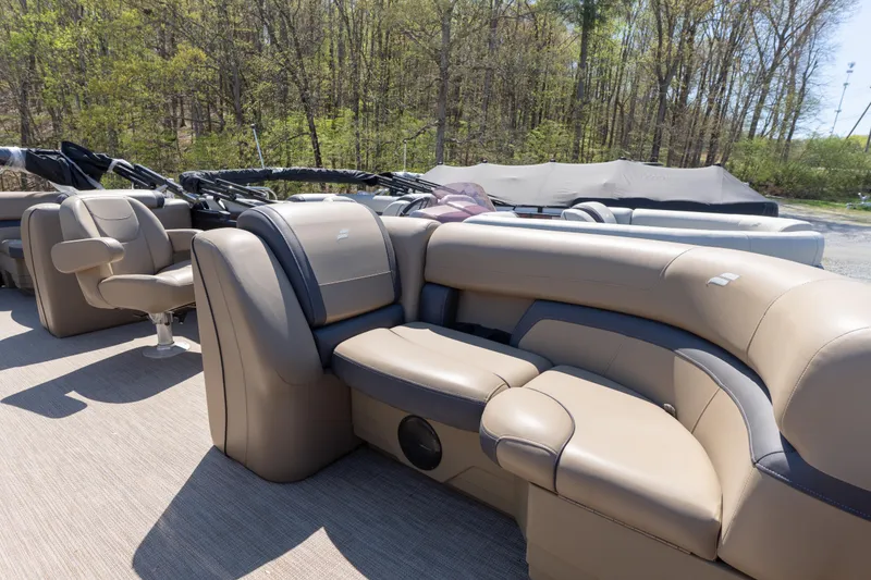 Slide: The Image of Luxurious seating on 2025 Starcraft EXS 3 boat, surrounded by lush greenery. - 5