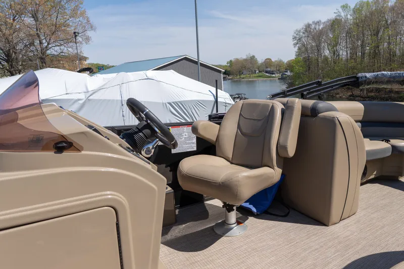 Slide: The Image of 2025 Starcraft EXS 3 boat interior with beige seating and steering wheel. - 8