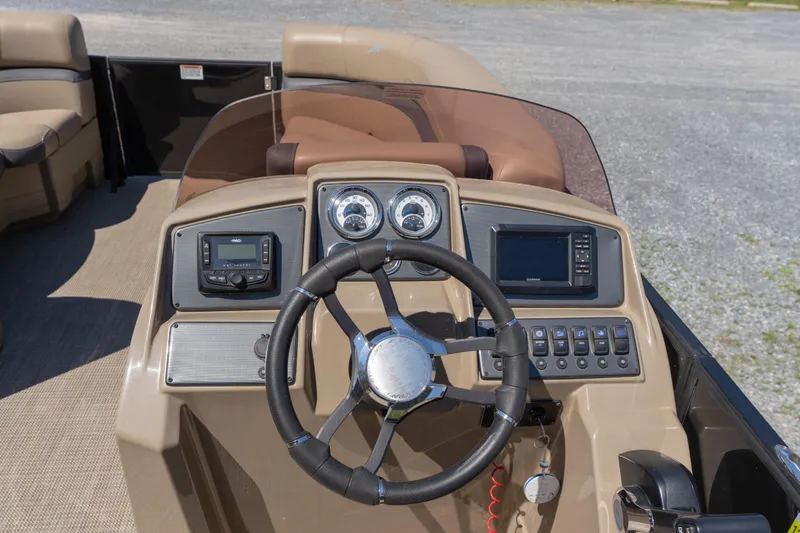 Slide: The Image of 2025 Starcraft EXS 3 boat dashboard with steering wheel and navigation controls. - 9