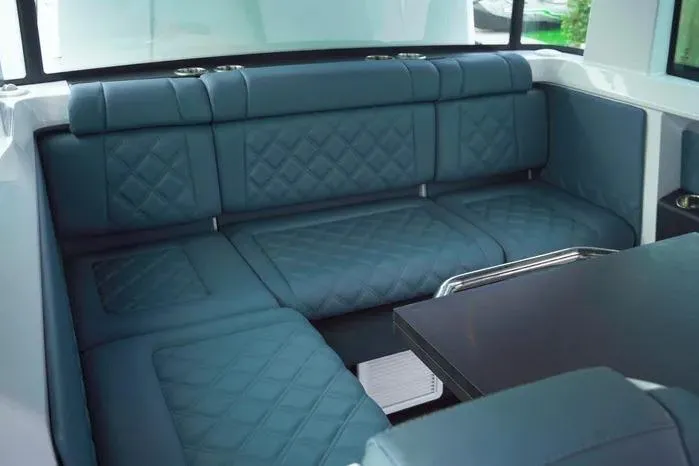 Slide: The Image of Luxurious interior seating of 2023 Axopar 37 XC Cross Cabin with quilted blue upholstery. - 12