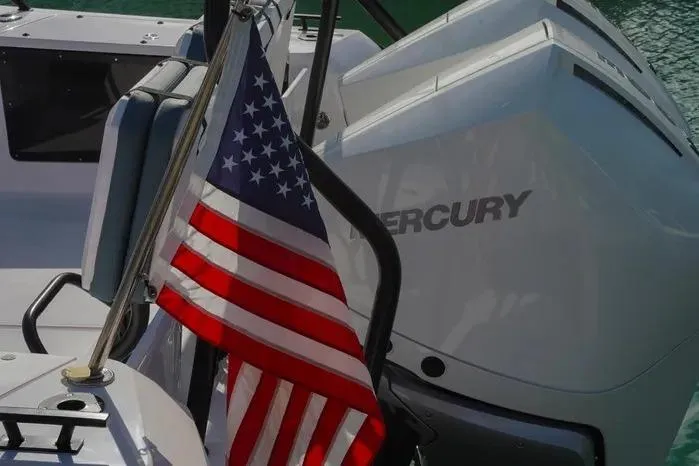 Slide: The Image of American flag on 2023 Axopar 37 XC Cross Cabin with Mercury engine. - 15