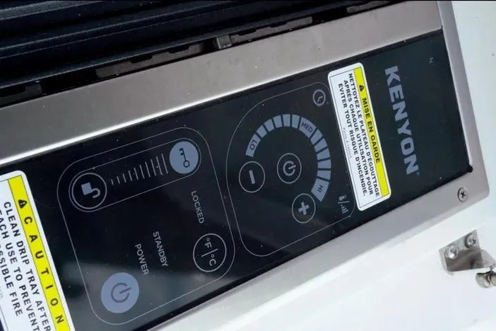 Slide: The Image of Control panel of a Kenyon appliance on a 2023 Axopar 37 XC Cross Cabin. - 18
