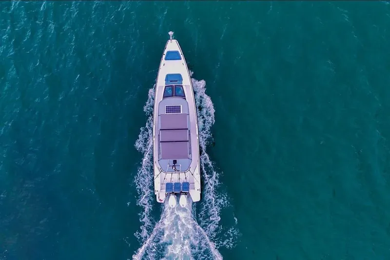 Slide: The Image of Aerial view of 2023 Axopar 37 XC Cross Cabin cruising on blue water. - 3