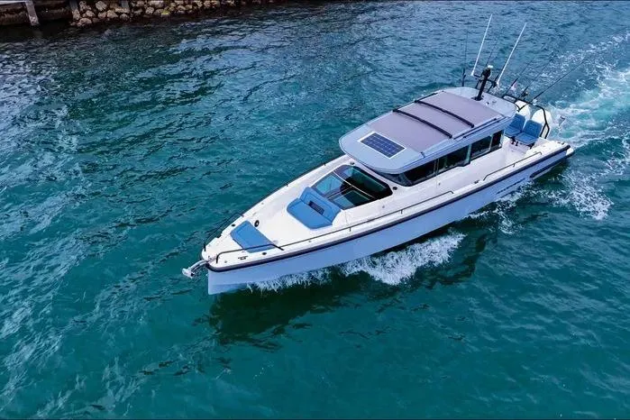 Slide: The Image of 2023 Axopar 37 XC Cross Cabin cruising on clear blue water. - 7