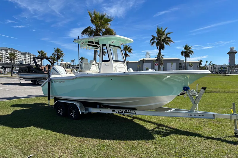 The Image of 2026 Key West 239 FS boat on trailer, parked on grass with palm trees in background. - 0
