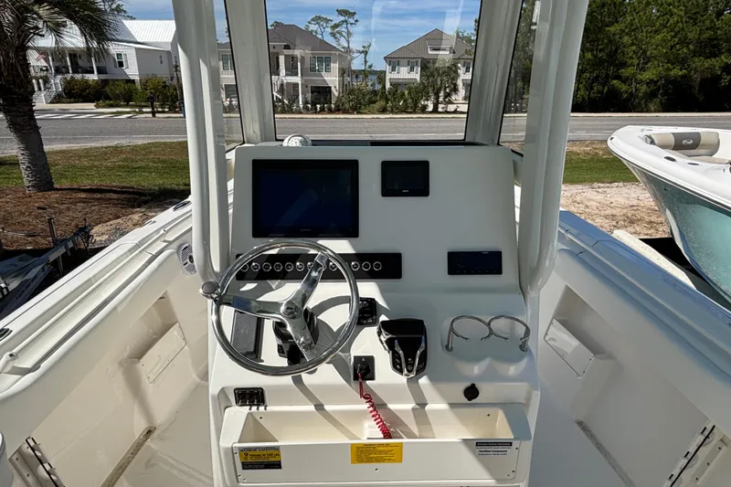 Slide: The Image of 2026 Key West 239 FS boat dashboard with steering wheel and controls. - 8