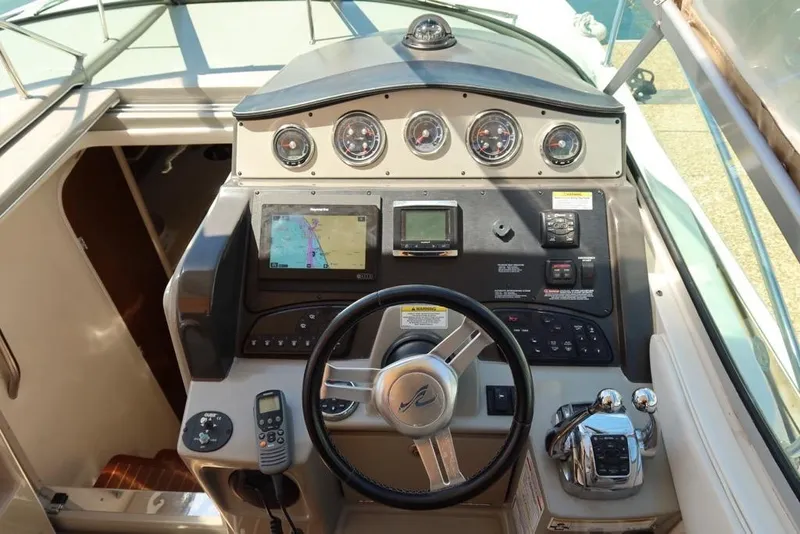 Slide: The Image of Cockpit of 2014 Sea Ray 330 Express Cruiser with navigation controls and steering wheel. - 10