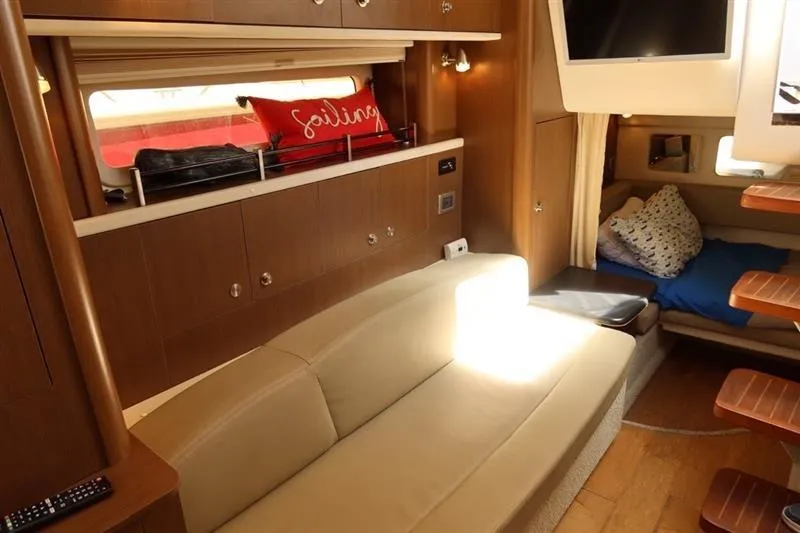 Slide: The Image of Luxurious interior of 2014 Sea Ray 330 Express Cruiser with beige seating and wooden accents. - 11