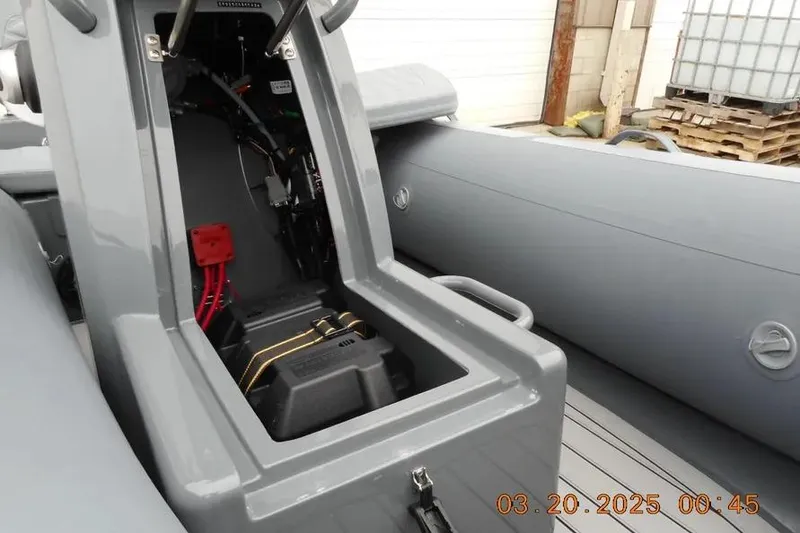 Slide: The Image of 2025 Highfield Sport 390 boat interior showing open storage compartment and wiring. - 10