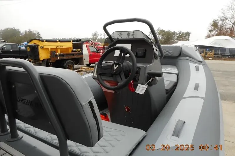 Slide: The Image of 2025 Highfield Sport 390 boat interior with steering wheel and seating. - 6