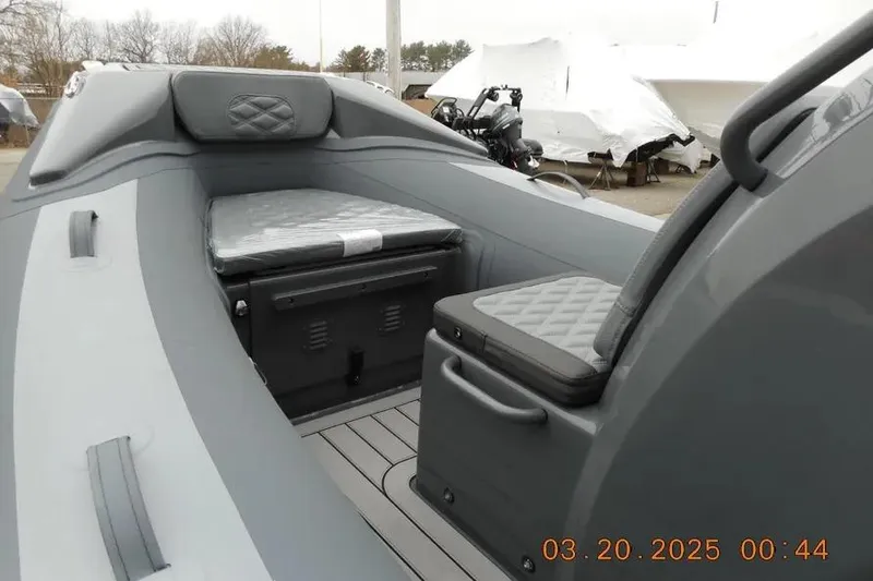 Slide: The Image of 2025 Highfield Sport 390 boat interior with cushioned seating and storage compartments. - 8