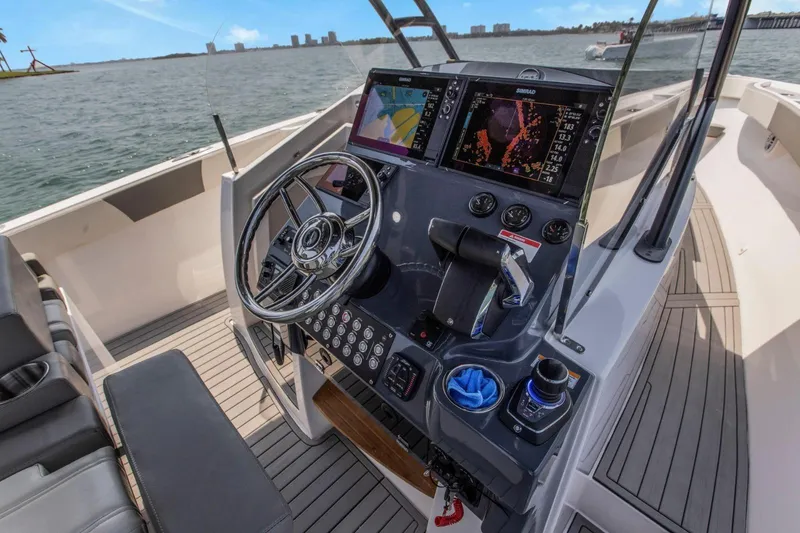 Slide: The Image of Helm of 2026 SeaWell 345XL boat with advanced navigation systems and controls. - 14