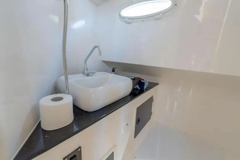 Slide: The Image of Compact bathroom interior of SeaWell 345XL boat, featuring a modern sink and porthole window. - 16