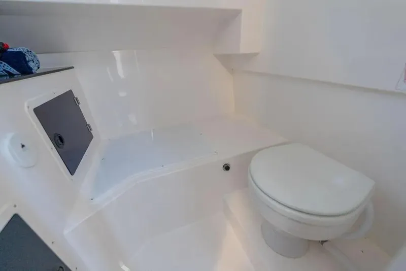 Slide: The Image of Interior of SeaWell 345XL 2026 boat featuring a compact marine toilet. - 17