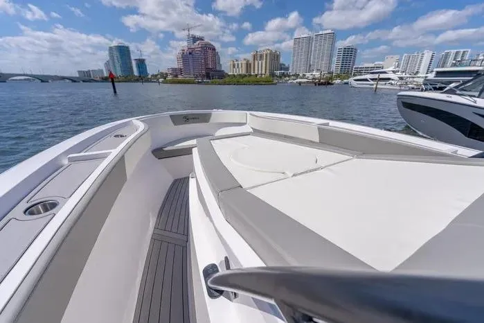 Slide: The Image of Modern SeaWell 345XL boat, 2026 model, docked with city skyline in background. - 6