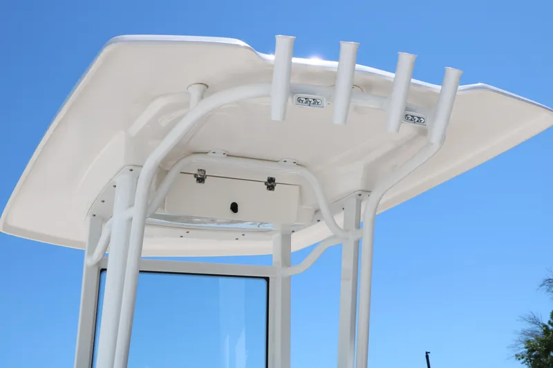 Slide: The Image of T-top of 2026 Robalo 246 Cayman boat against clear blue sky. - 11