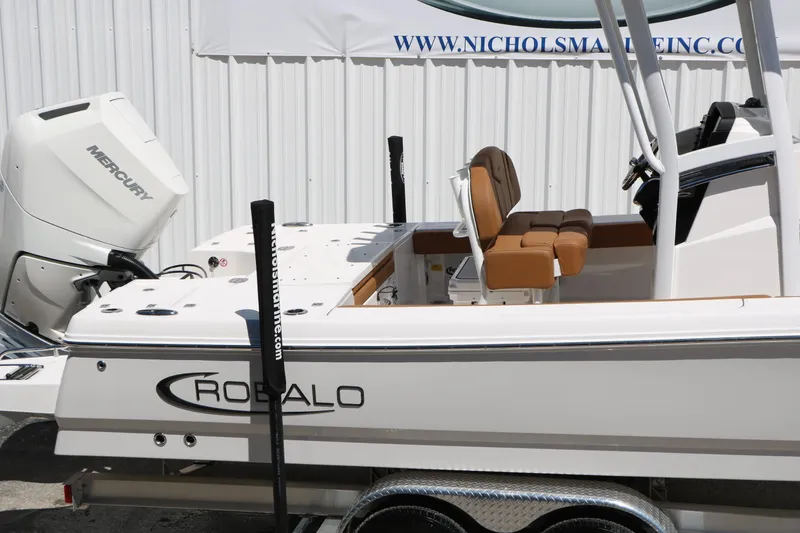 Slide: The Image of 2026 Robalo 246 Cayman boat with Mercury engine, displayed on trailer. - 13