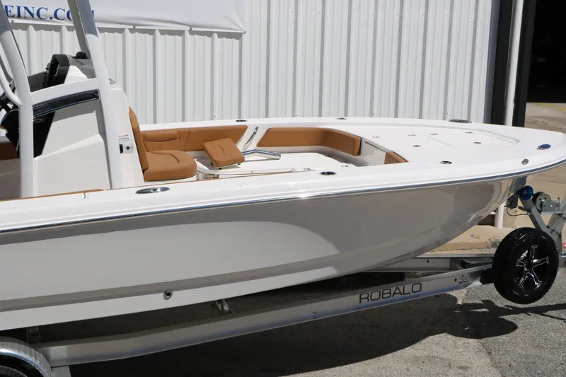 Slide: The Image of 2026 Robalo 246 Cayman boat on trailer, featuring sleek design and tan seating. - 14